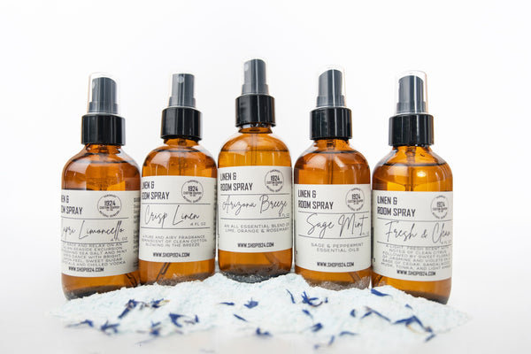 Five bottles of room spray with labels on a white background